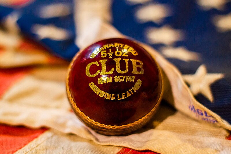 cricket ball resting an an american flag