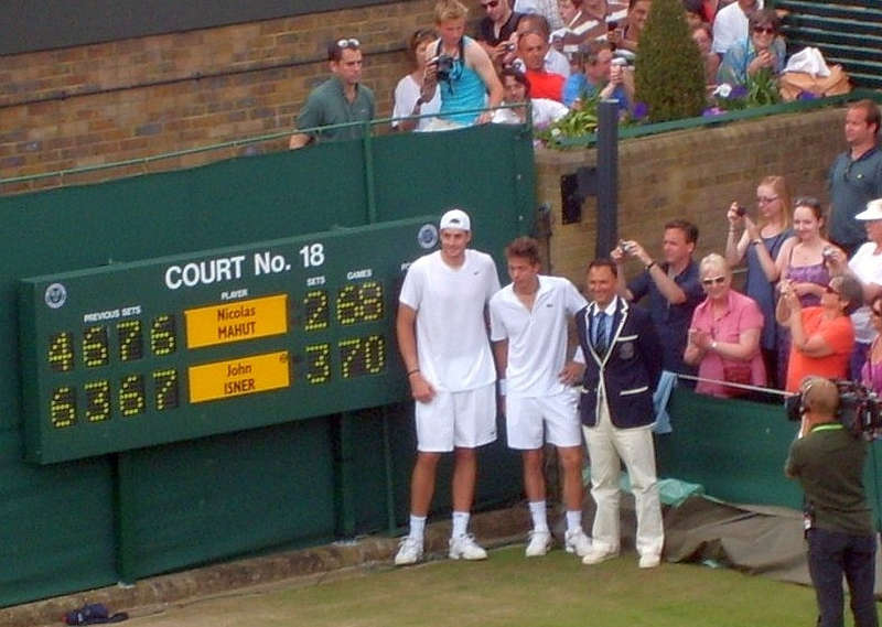 Posing by Scoreboard Longest Tennis Match